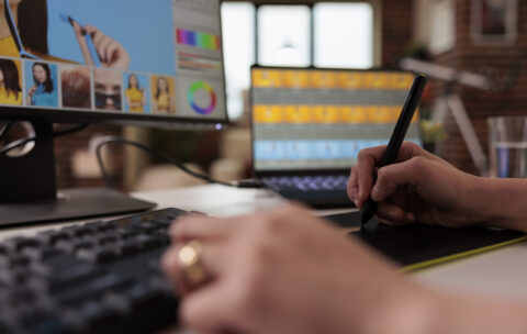 Female editor using stylus on graphic tablet